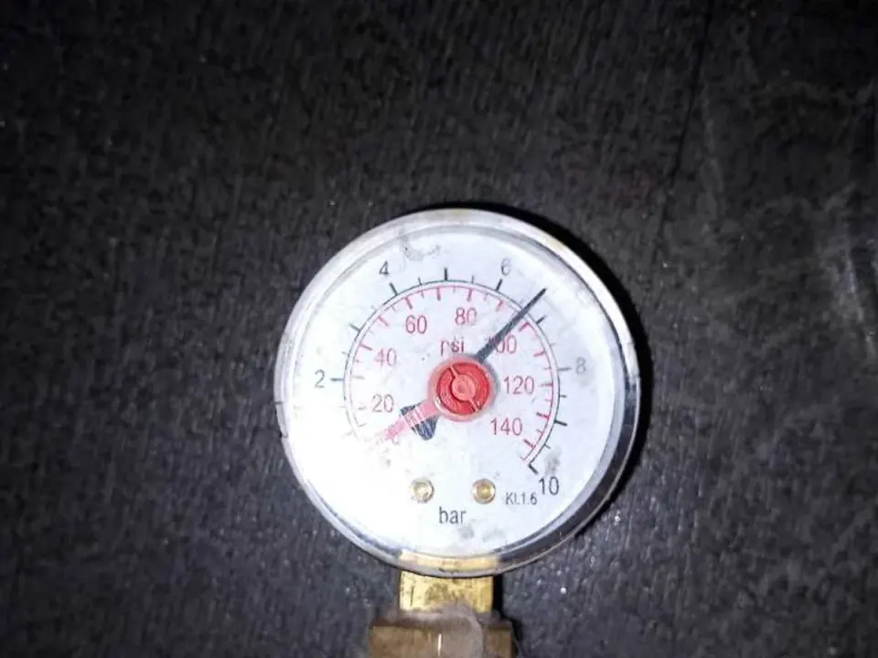 Pressure gauge showing high water pressure on cold mains supply during leak detection