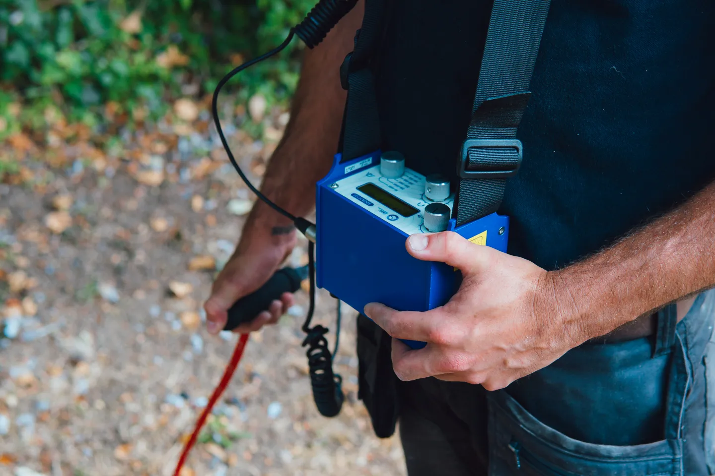 ADI Leak Detection engineer outdoors with acoustic leak detection equipment